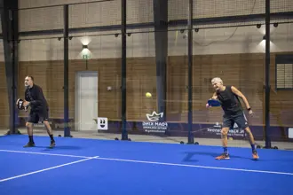Two men playing padel tennis
